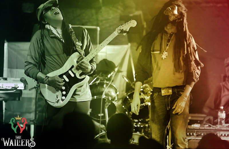 Julian Junior Marvin and Josh David Barrett on stage playing with The Wailers